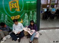 Chinese rest outside an internet cafe in Beijing Friday, Oct. 5, 2007. IReporters Without Borders, an international media rights group called on China on Wednesday to loosen controls on Internet news and personal expression, calling the country's system of censorship an insult to the spirit of online freedom. (AP Photo/Ng Han Guan)