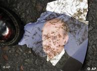 A muddy piece of paper on the ground showing President Vladimir Putin 