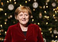 German Chancellor Angela Merkel in front of an illuminated Christmas tree