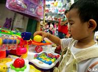 A young boy plays with plastic toys