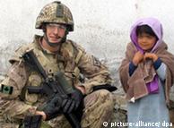 Canadian soldier next to a girl in Kandahar