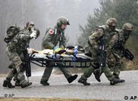 Soldiers of the French- German Brigade rescue  a wounded soldier during  the NATO multi-national military exercise