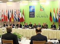NATO defense ministers sit at a table in Vilnius, Lithuania, 