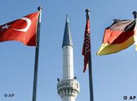 A minaret with Turkish and German flags