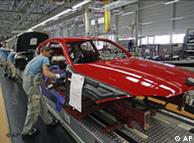 Workers fit the body of a BMW 1 in the BMW plant in Leipzig