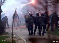 Serb protesters throw stones and other missiles at French NATO peacekeeping troops