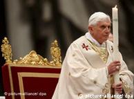 Pope Benedict XVI holds a candle during the Easter vigil mass on Saturday