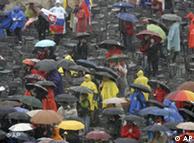 People under umbrellas attend mass led by Pope Benedict XVI in St. Peter's Square 