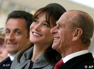Carla Bruni-Sarkozy and Prince Philip share a joke as she and her husband watch the ceremonial welcome at Windsor Castle