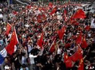 Protestors hold Chinese national flags during a demonstration against Carrefour supermarket 