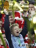Bayern Munich soccer keeper Oliver Kahn lifting trophy