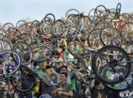 Participants of the Critical Mass bicycle ride lift their bicycles above their heads following their ride across Budapest, Hungary