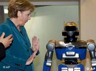 German Chancellor Angela Merkel with a robot at the Hanover Trade Show