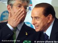 Umberto Bossi whispering to Silvio Berlusconi