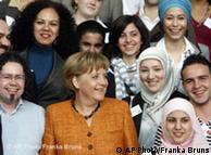 Merkel with young women, some in headscarves
