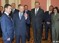 Russian President Dmitry Medvedev, left, and top officials, background, listen to Prime Minister Vladimir Putin