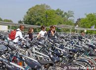 Women lock their bikes at the train station in Bruges