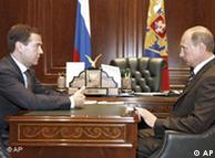 Putin and Medvedev seated opposite one another 