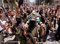 Palestinian militants carrying the body of Moutaz Tafesh, an Islamic Jihad militant, as his funeral takes place in Gaza City in the Gaza Strip on 17 June 2008. 