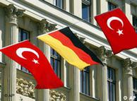 A German and two Turkish flags are tightened between houses in Berlin