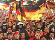 German riot police officers stand in the crowed of German and Turkish soccer fans at the ' Fan-Mile' , a public viewing zone in central Berlin