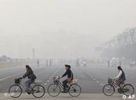 ** FILE ** Chinese cycle through smog and pollution over Beijing's Tiananmen Square Thursday , May 1, 2008. Beijing's Olympic shutdown begins Sunday, July 20, 2008, a drastic plan to lift the Chinese capital's gray shroud of pollution just three weeks ahead of the games.(AP Photo/Oded Balilty) Creation Date:    5/1/2008 14:10:09 China_Olympia_FRA107.jpg