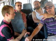German mountain climbers sit in a minibus after being released