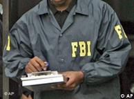 FBI agent wearing a jacket with FBI written on it writes on a pad of paper.