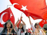 Female protestors wave Turkish flags during an anti-government protest 