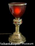 Foto of gold chalice with red top 