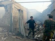 Emergency personnel at work in front of buildings destroyed in an air raid in the village of Tkviavi, Georgia, Monday, Aug. 11, 2008. 