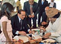 Berlusconi signing a friendship treaty with Gadhafi in 2008