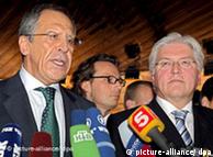 Foreign ministers Lavrov and Steinmeier in front of microphones at a news conference in July
