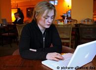 A woman using a notebook computer in a cafe