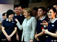 German Chancellor Angela Merkel greets Chinese workers during her visit to the Daimler auto factory in Beijing