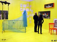 Visitors look at artworks at Berlin's Art Forum fair