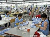 Vietnamese workers in Hanoi produce garments for a German textile company   