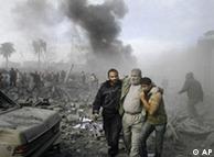 An injured Palestinian is helped from the rubble following an Israeli missile strike in Rafah, southern Gaza Strip