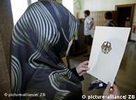 فتاة مسلمة تتتسلم وثيقة حصولها على الجنسية الألمانية