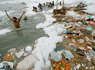 Children swimming in a garbage-strewn river