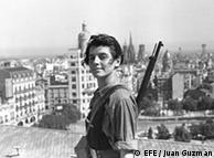 A young Republican fighter in Barcelona with a gun slung over her shoulder.