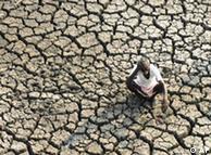 An Indian farmer on dried out ground