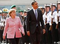 German Chancellor Angela Merkel and U.S. President Barack Obama walk along the guard of honour in Baden-Baden