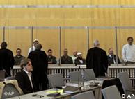 The defendents appear in in the courtroom in Duesseldorf.