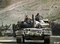 With their machineguns covered with tarpaulin, a convoy of Soviet M-72 tanks rumbles down a highway leading to Kabul the capital of Afghanistan, April 27, 1988.