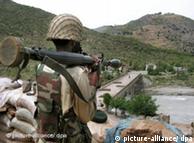 A Pakistani soldier watches over a bridge during a military offensive against the Taliban