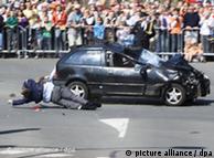 Bystanders are dragged along by the car