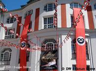 Red banners outside the theatre building with pretzels 