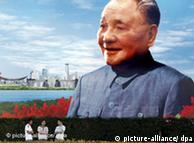 Tourists in front of portrait of Deng Xiaoping