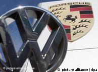A VW badge in front of the Porsche shield